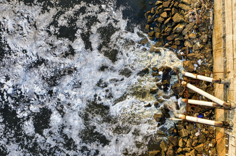 Water being released from pipes into a body of water